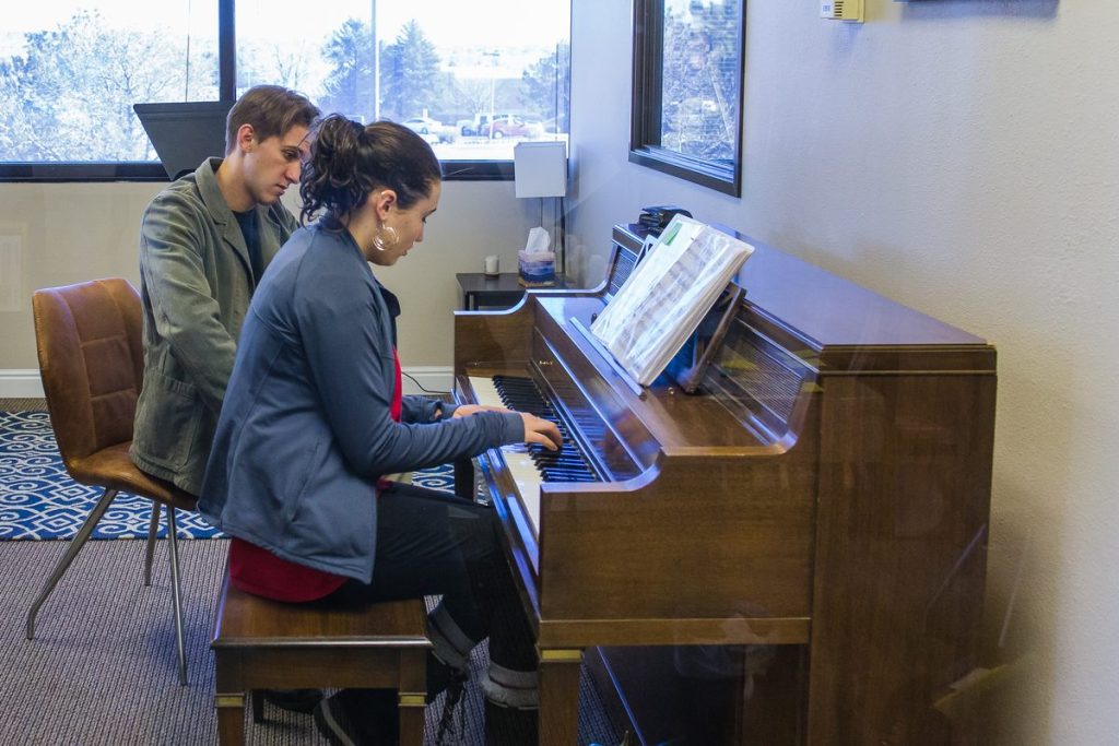 Adult piano student taking a lesson at Rocky Mountain Academy of Music in Colorado Springs