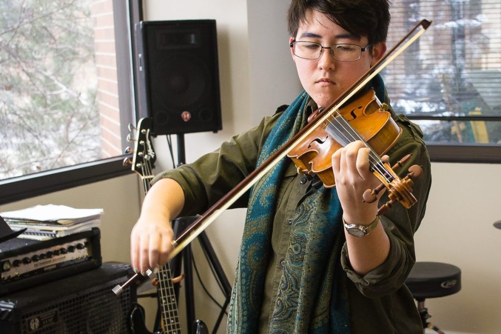 Adult violin student playing at Rocky Mountain Academy of Music in Colorado Springs