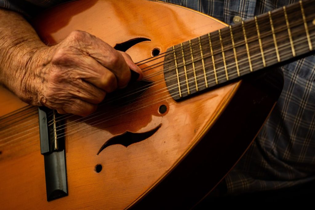 Close-up of hands strumming a mandolin