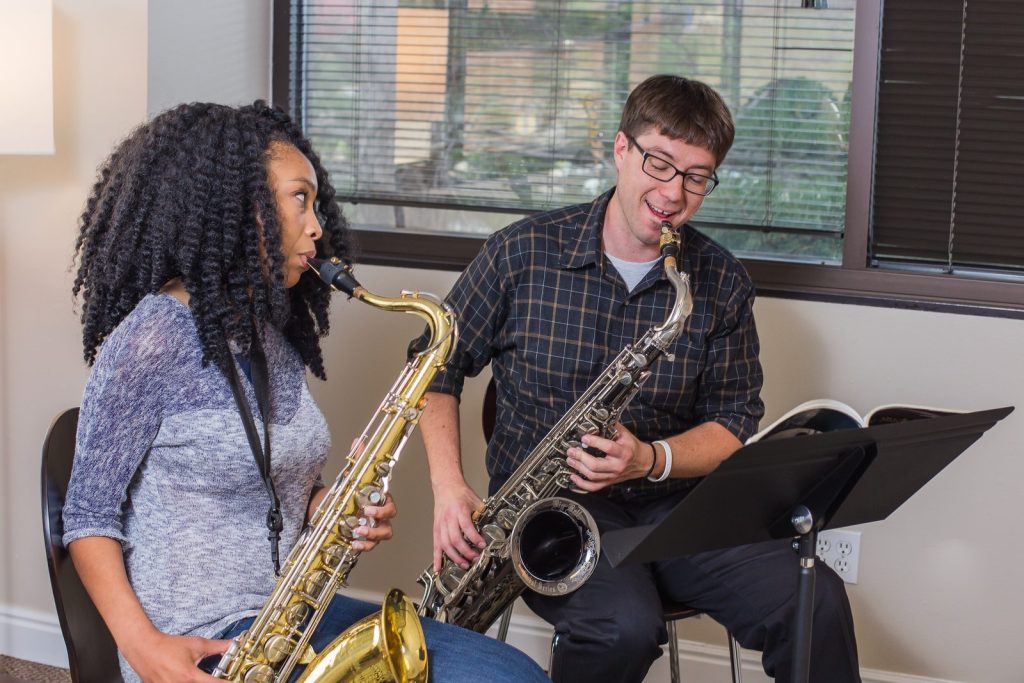 Saxophone teacher and student playing tenor saxophones during a lesson in Colorado Springs