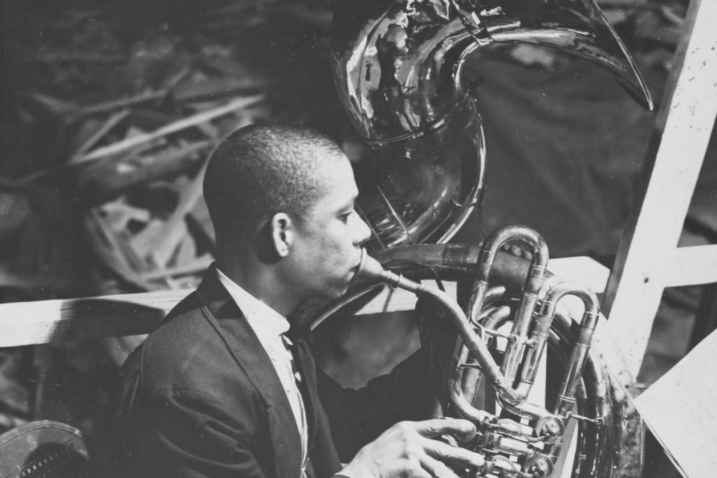 Vintage photo of a sousaphone player in a band, the marching tuba taught in tuba lessons